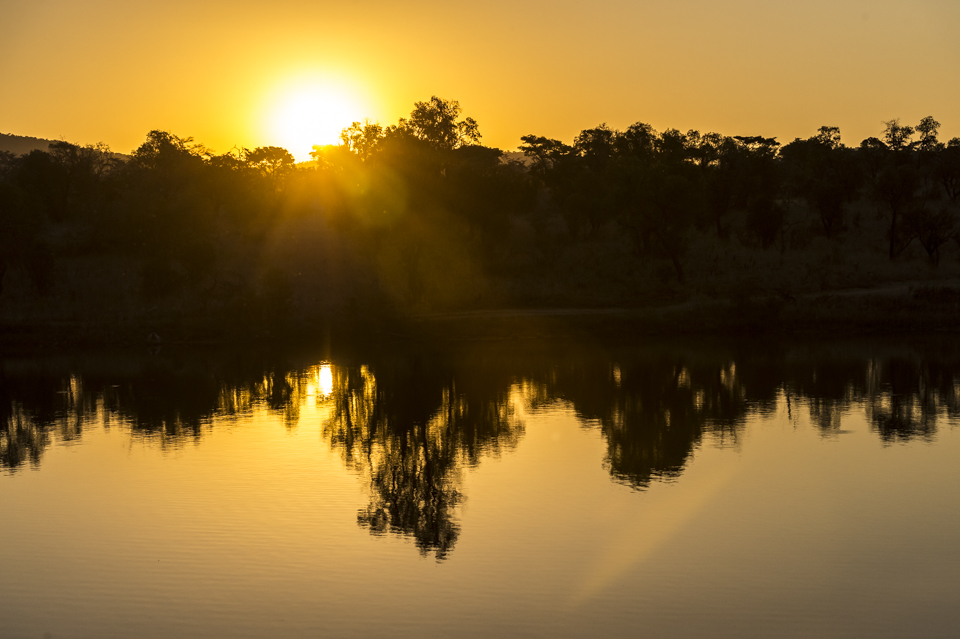 Golden sunset reflected off a watering hole in the Mabula game reserve
